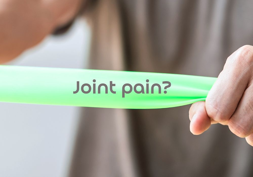 Hands stretching a resistance band with the words 'Joint pain?' on it