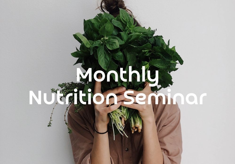 Woman holding herbs with the text 'Monthly Nutrition Seminar'